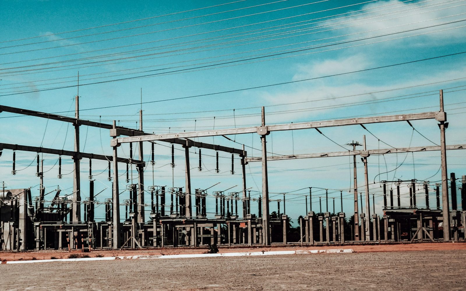 High-voltage electrical substation equipment and overhead power conductors.